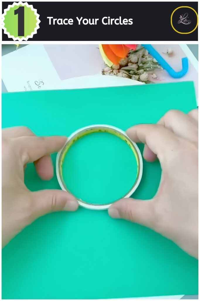Tracing a circle inside a roll of tape on green paper with a pen