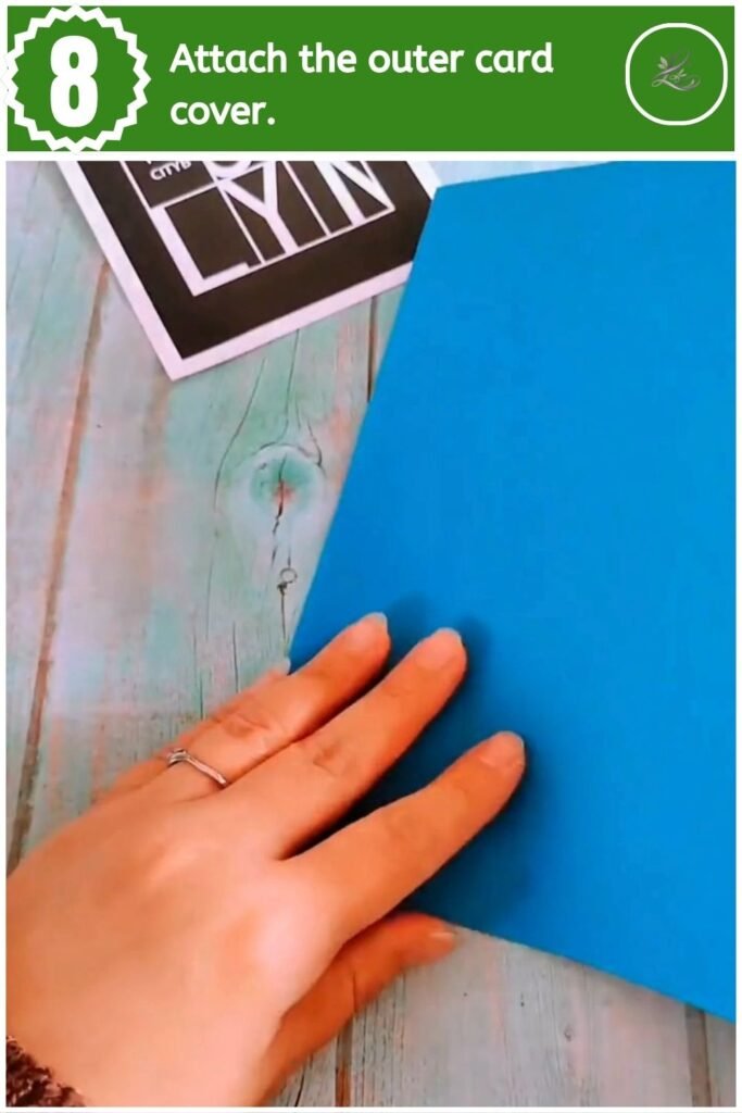 Adhering the inner black pop-up card to a solid blue outer cardstock cover.