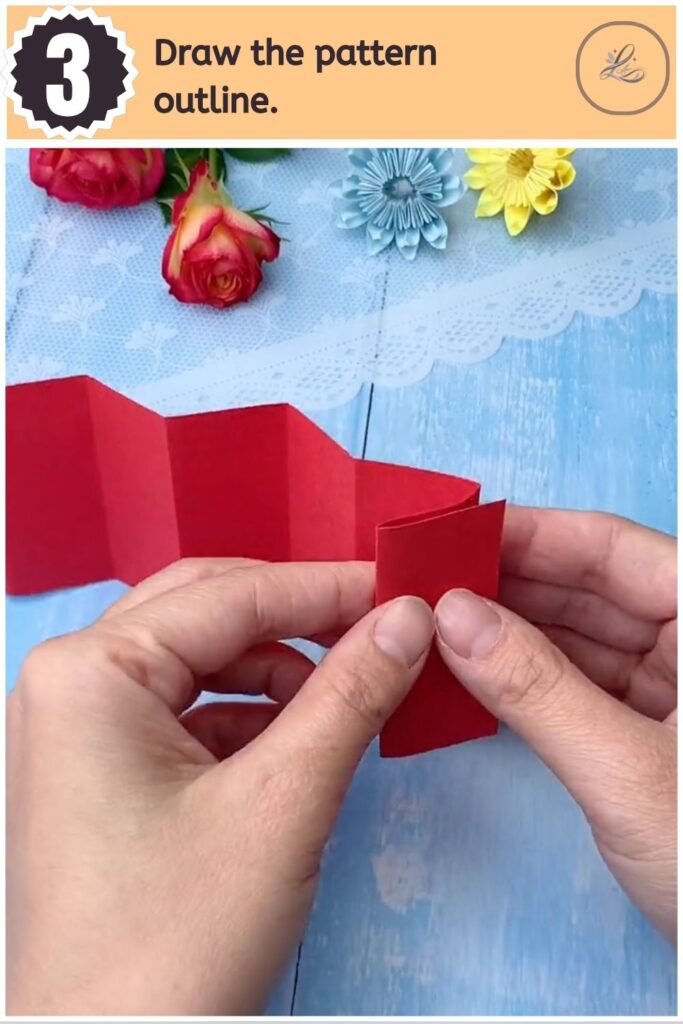 Pencil outline of half a Chinese character drawn on folded red paper.