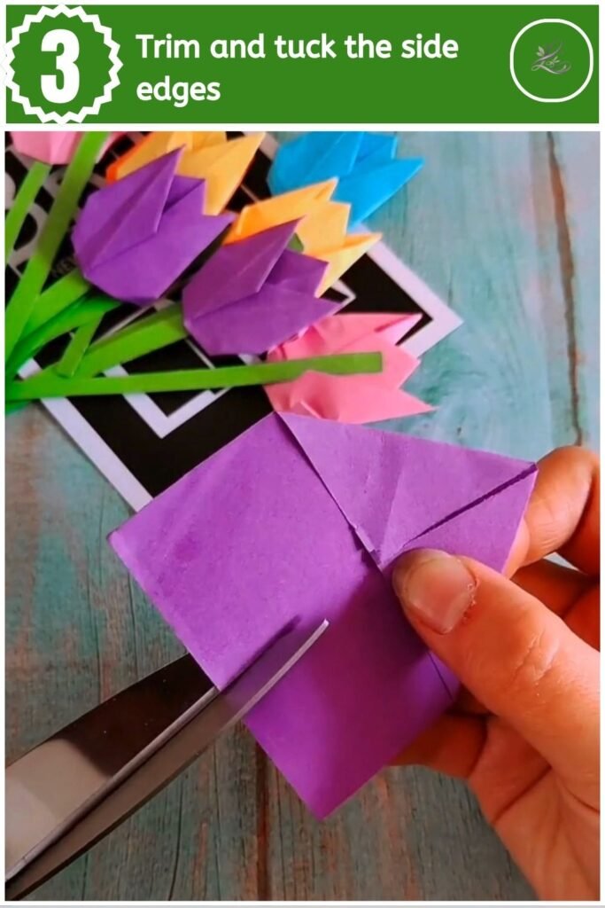 Trimming the bottom edge of folded purple paper with scissors.