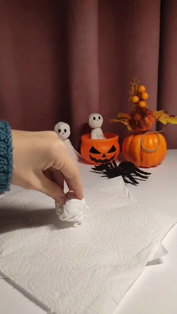 Easy DIY Paper Towel Ghosts (5-Minute Halloween Craft) Draping flat paper towel over ball to form ghost skirt