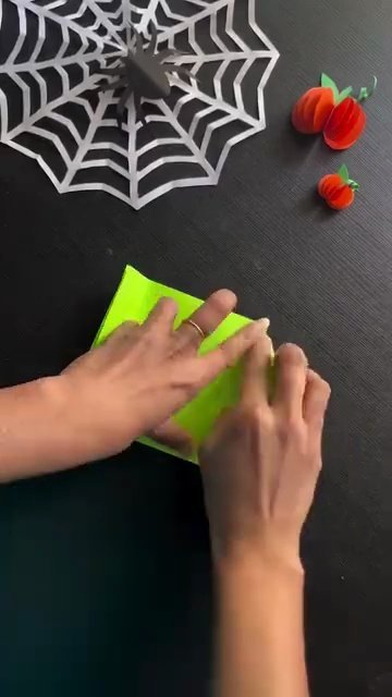 Folding corners and side flaps into hexagonal treat pouch shape