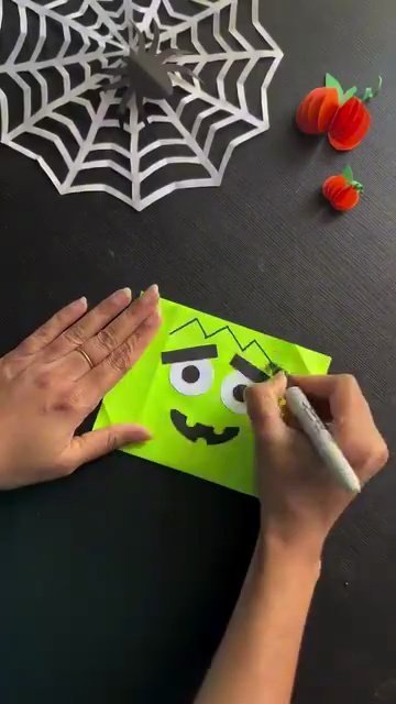 Drawing black marker hair and stitches on DIY Frankenstein bag