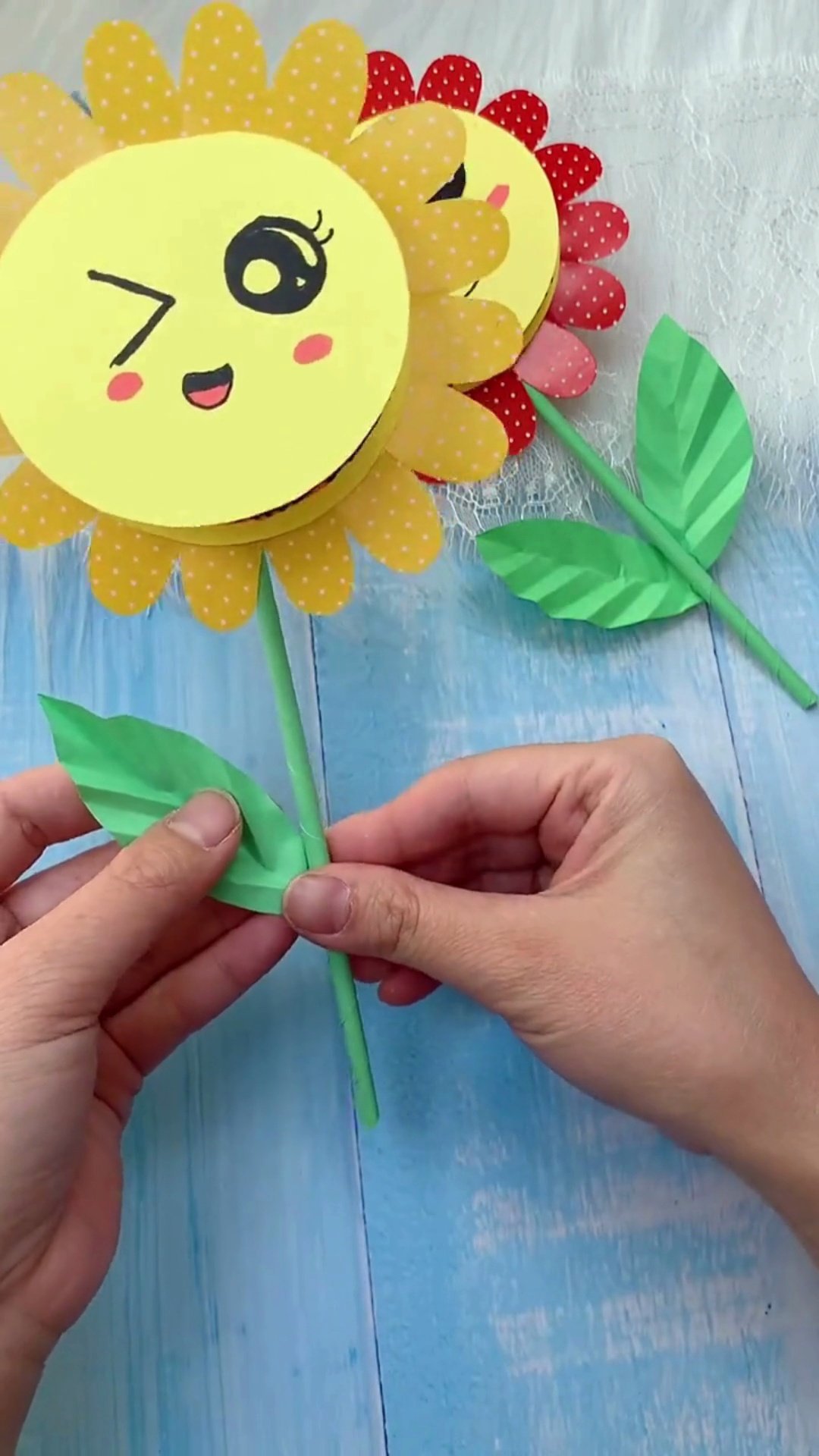 Easy DIY Paper Sunflower Card (With Surprise Flip Message!) Attaching green paper stem and pleated leaves to sunflower card